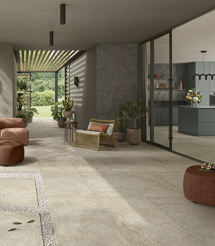 Pulse Sand creates seamless continuity between indoor and outdoor spaces with warm, natural stone-effect ceramic surfaces, ideal for contemporary and welcoming settings.